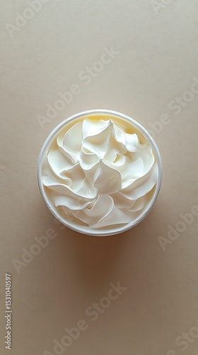 Overhead View of White Container with Smooth Creamy Filling on Wood Surface