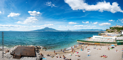 panoramic photo of Castellammare di Stabia beach with Vesuvius and the blue waters of the Gulf of Naples. Italy