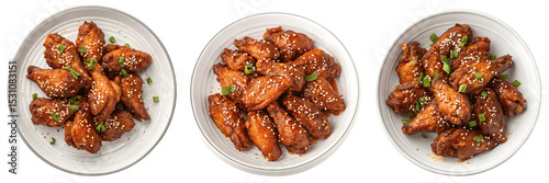 A Set for Three plates of glazed chicken wings with sesame seeds