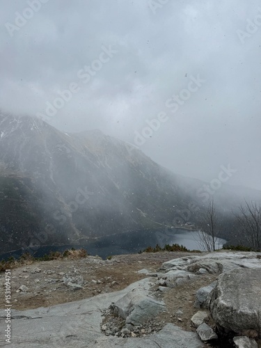 Fototapeta Naklejka Na Ścianę i Meble -  Polish mountains landscape. Eye of the Sea lake. Foggy sky. Beautiful landscape from Carpathian Mountains in Poland.