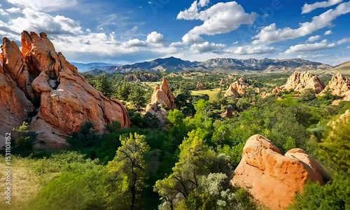 Stunning Panoramic View of Red Rock Formations and Lush Green Valley