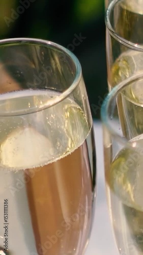 A glass of champagne stands on the festive table at the wedding of the bride and groom. Catering service on banquet food set on birthday, wedding celebration or business conference event venue