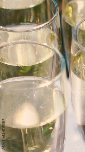 A glass of champagne stands on the festive table at the wedding of the bride and groom. Catering service on banquet food set on birthday, wedding celebration or business conference event venue