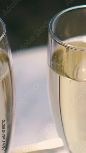 A glass of champagne stands on the festive table at the wedding of the bride and groom. Catering service on banquet food set on birthday, wedding celebration or business conference event venue