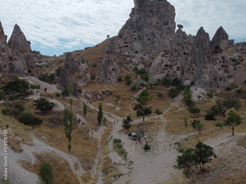 A drone view of Göreme in Cappadocia, revealing cave homes, fairy chimneys, and ancient landscapes bathed in soft light and rich earthy tones.