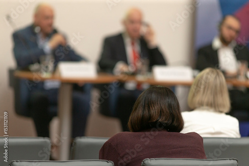 A panel discussion that includes a variety of speakers, actively engaging with an enthusiastic audience within the collaborative and dynamic atmosphere of a professional conference setting