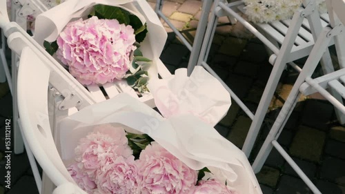 beautiful wedding bouquet of the bride of white roses and green eucalyptus close-up, romantic atmosphere before the outdoor ceremony, floristry and decoration