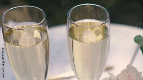 A glass of champagne stands on the festive table at the wedding of the bride and groom. Catering service on banquet food set on birthday, wedding celebration or business conference event venue