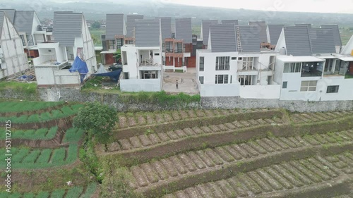 Newly Developed Residential Area Surrounded by Lush Greenery and Agricultural Fields in Scenic Landscape