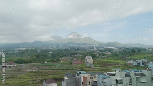 Breathtaking Panoramic View of Majestic Mountain Overlooking Verdant Fields and Charming Towns