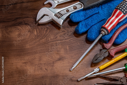 Labor Day concept. American flag and construction tools on dark background, above view.