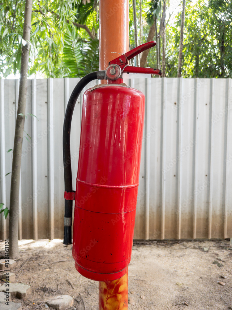 Fototapeta premium Fire Extinguisher on Construction Site Pole.