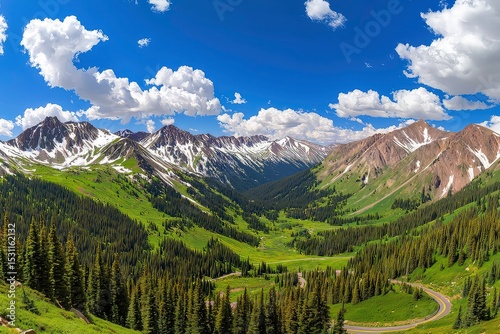 Majestic mountain landscape, winding mountain road, snow-capped peaks