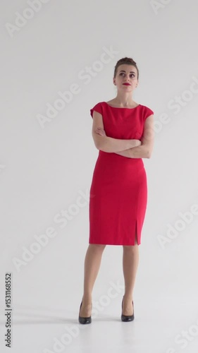 Unhappy woman suffers from boredom and fatigue on a white background, conveying loneliness, melancholy, and anxiety with a subdued and disengaged expression. Vertical video.