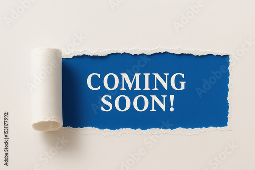 An anticipation future developments is revealed as a torn paper edge uncovers a bold message promising upcoming opportunities and progress