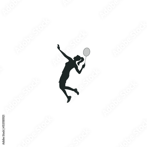 Silhouette of female badminton player serving in mid air with racket