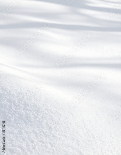 Fresh snow blanket with subtle shadows creating a serene winter landscape