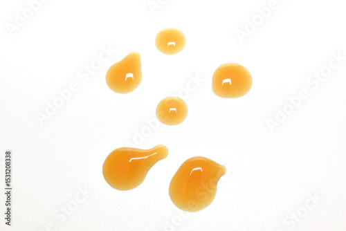 Cough syrup drops on white background.
