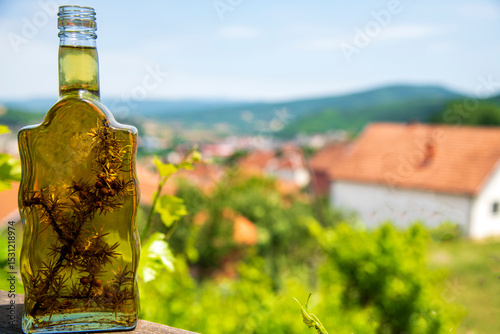 Homemade juniper brandy with mountains in the background.