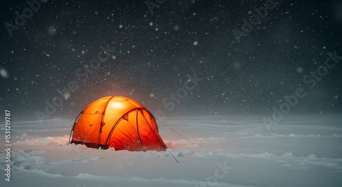 Tent glowing in snowy landscape at night