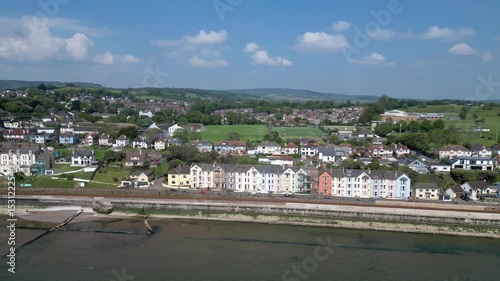 Dawlish, Devon, England: DRONE VIEWS: The drone circles a row of Victorian terrace houses on the seafront showing the town and countryside. Dawlish is a popular UK holiday destination. 