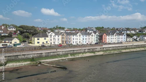 Dawlish, Devon, England: DRONE VIEWS: An Intercity train passes a row of Victorian terrace houses on the seafront. Dawlish is a popular UK holiday destination on route to west Devon and Cornwall. 