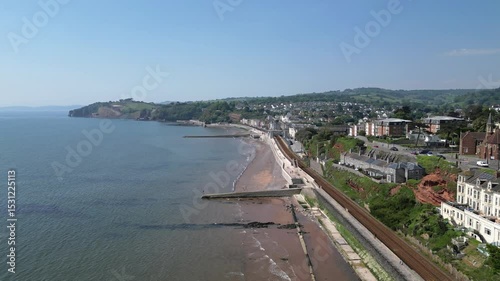 Dawlish, Devon, England: DRONE VIEWS: Flying alongside the railway track, the drone shows seafront properties arriving at the town quay and railway station. Dawlish is a popular UK holiday destination