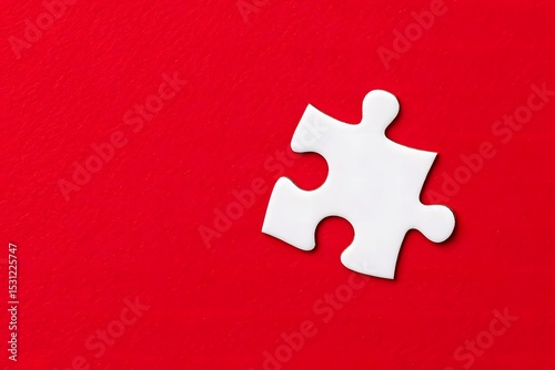 Single white puzzle piece on red background