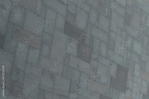 Perfect gray paving slabs. Road surface from blocks of different sizes. Gray geometric background.