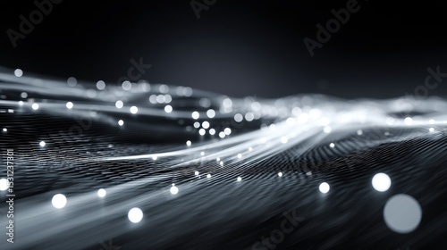 Dynamic network visualization featuring dots of light and interconnected trails in grayscale tone