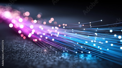Fiber optic cables glow with vibrant pink and blue lights conveying technology concept perfectly.