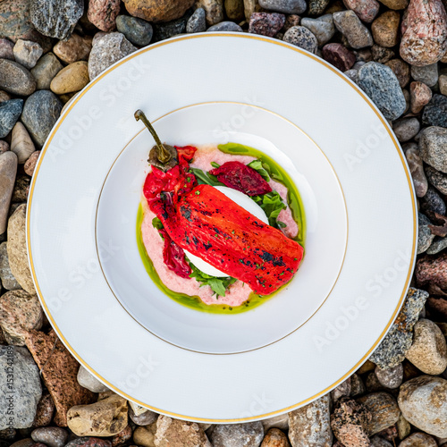 Fresh burrata oozes deliciousness, accompanied by smoky grilled pepper and vibrant herbs