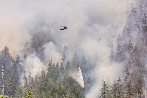 Helicopter Fighting a Forest Fire in Squamish, BC, Canada Amid Dense Smoke