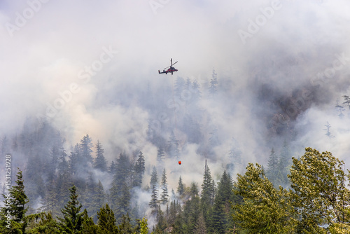 Helicopter Extinguishing Forest Fire in Squamish, BC Amid Smoke