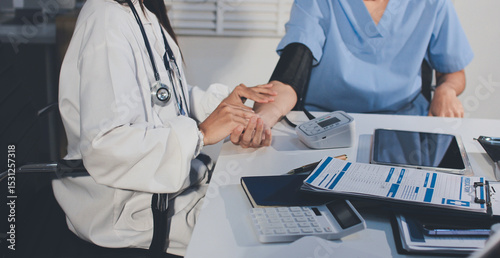 Fotografie Doctor checking patient arterial blood pressure in hospital
