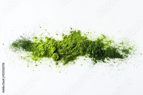 Green and dark-green powdered substance scattered on white background