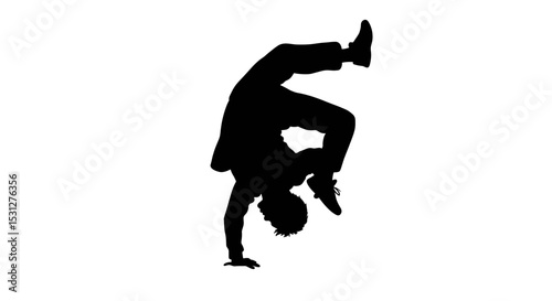 Silhouette of man performing a handstand in dynamic pose  