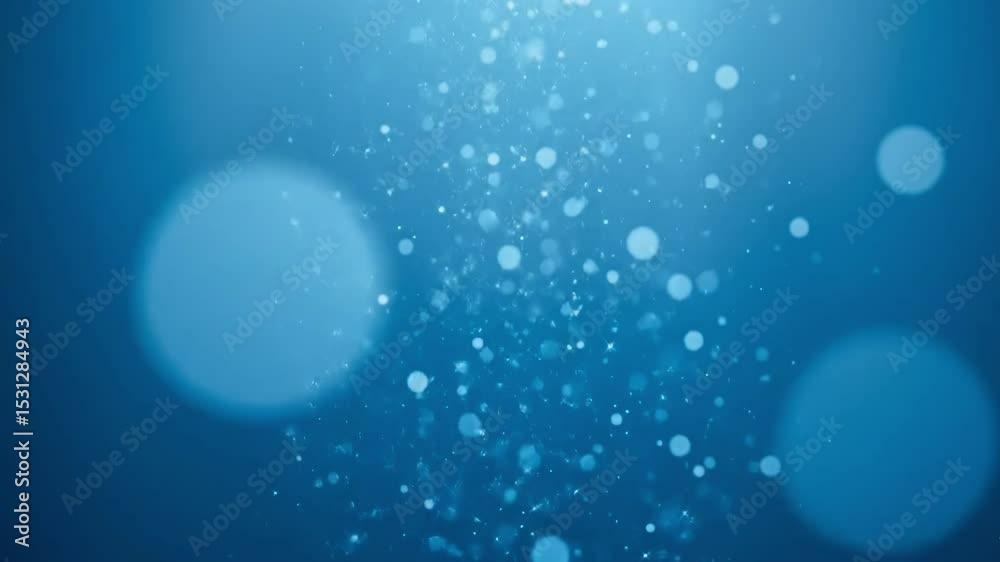 Abstract blue background with sparkling particles and a bright glow effect