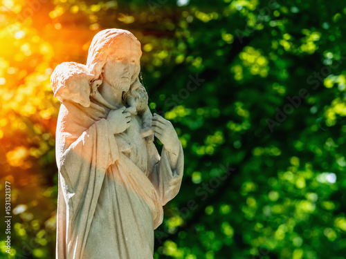 Ancient statue of Jesus Christ Good Shepherd. Copy space for design. Horizonttal image.