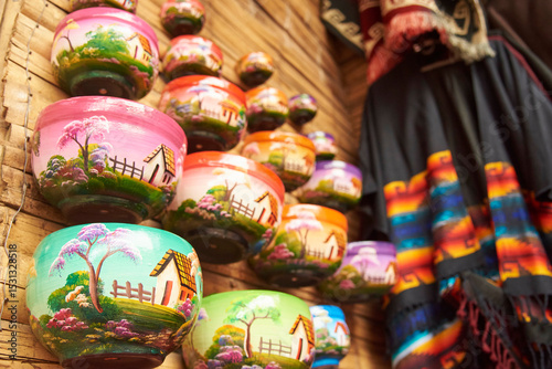Sale of handmade ceramic pots, painted with colorful traditional scenes, in Raquira, Colombia.
