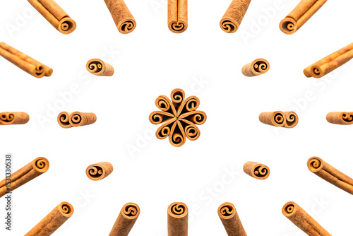 Cinnamon sticks arranged in a star pattern, isolated on white