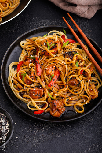 Asian food: Noodles with chicken and vegetables in teriyaki sauce