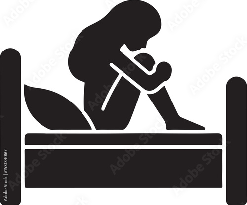 A silhouette of a person sitting on a bed with their head down and arms around their knees