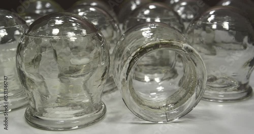 Glass cups for medical purposes, rehabilitation, increasing blood flow, lymphatic drainage, back treatment. Used in folk, alternative medicine for cupping massage, vacuum therapy. Cinema 4K video