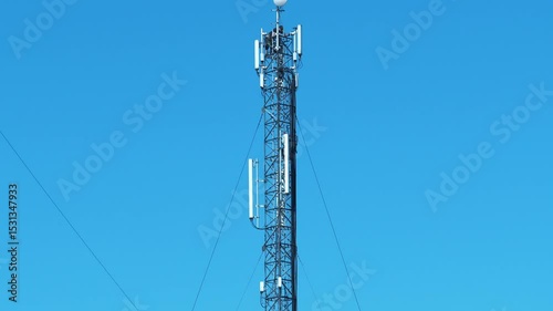 Maintenance staff at the work. High-altitude work. Two workmen repair a cell tower. Cell tower on blue background