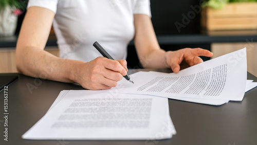 Fototapeta Naklejka Na Ścianę i Meble -  Completing important paperwork at a modern office workspace