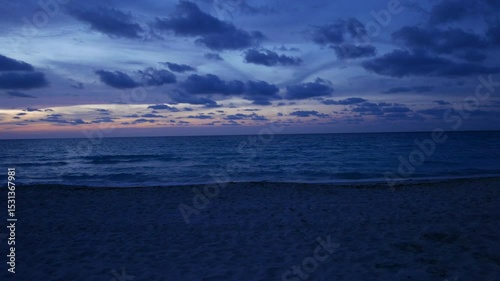 Early evening dusk sunset shot of a tropical Caribbean beach in Varadero, Cuba.  Panning shot.