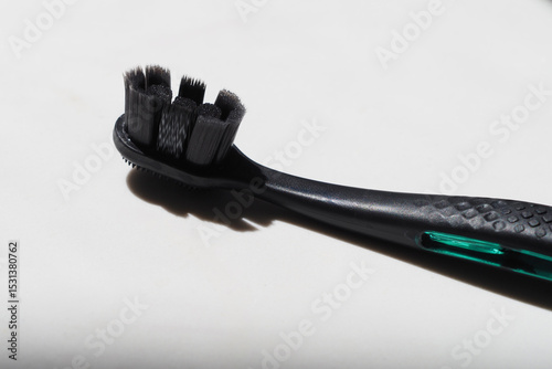 Close-up black toothbrush with ergonomic handle