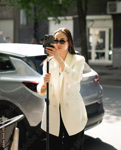 Stylish female content creator setting tripod