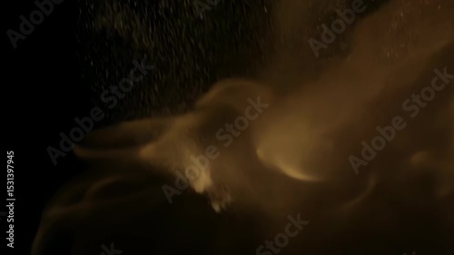 Abstract dynamic cloud of dust particles dispersing against black background in explosion
